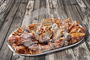 Plateful of Spit Roasted Pork Slices on Old Lacquered Cracked Peeled-off Wooden Garden Table