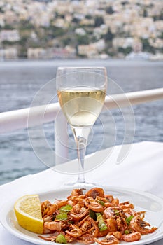 Plateful of Symi Shrimp Served ith a Slice of Lemon and a Glass of Greek White Wine