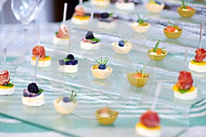 Plates with assorted finger food snacks on an event party or dinner