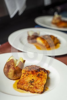 Plates with battered cod and roasted potatoes