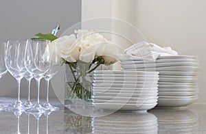 Plates, glasses & roses on the counter