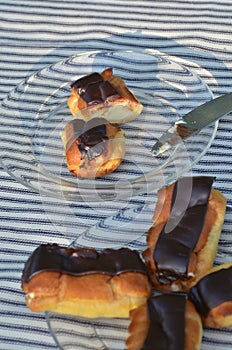 Plates of mini eclairs on checked tablecloth