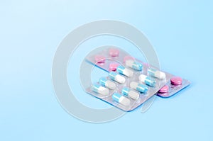 Plates of multi-colored tablets on a blue background