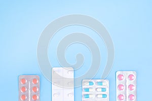 Plates of multi-colored tablets on a blue background