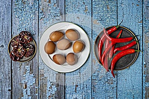 plates with raw eggs, ÃÂ±oras, red hot peppers