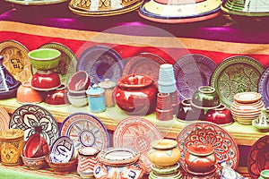 Plates, tajines and pots made of clay on the souk in Marocco.