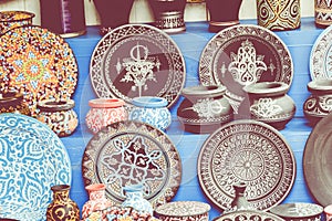 Plates, tajines and pots made of clay on the souk in Marocco.