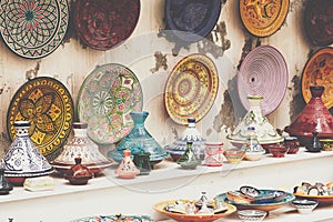 Plates, tajines and pots made of clay on the souk in Marocco.