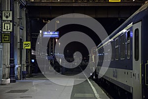 Platform of the Budapest Nyugati palyaudvar train station at night with a late evening train ready for departure