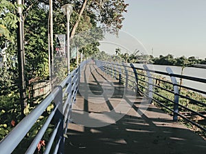A platform that looks quiet on the edge of the cisadane river for afternoon jogging. photo