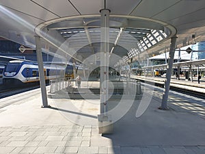 Platform of the renewed trainstation of Utrecht Centraal in the Netherlands with a train.