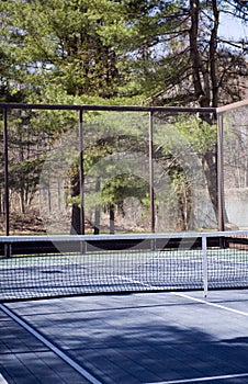 Platform tennis paddle court woods in suburban setting private club