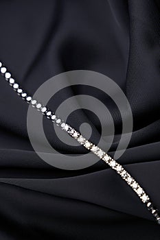 Platinum bracelet with diamonds on black silk background