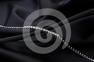 Platinum bracelet with diamonds on black silk background