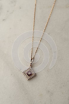 Platinum necklace with ruby pendant, marble background