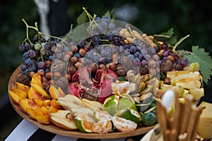 Platter of assorted fresh fruit, close-up, outdoor