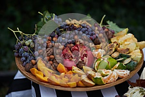 Platter of assorted fresh fruit, close-up, outdoor