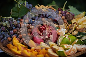 Platter of assorted fresh fruit, close-up, outdoor