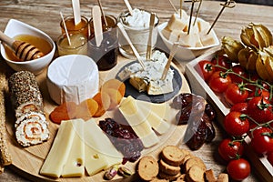 Platter of cheeses, fruit, jams