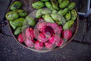 Platter of dragonfruit and green mangoes