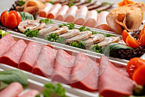 Platter of fresh meat cold cuts on table