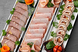 Platter of fresh meat cold cuts on table