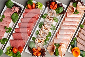 Platter of fresh meat cold cuts on table