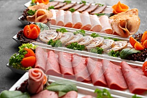 Platter of fresh meat cold cuts on table
