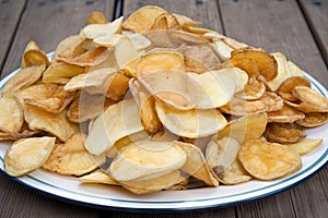 a platter of fried and salted potatoes chips, ready to devour