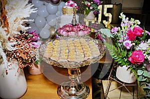 Platter with milk sweets decorating the table for the 15th birthday