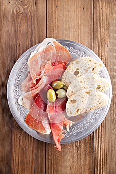 Platter of serrano jamon Cured Meat, Ciabatta, chorizo and olive