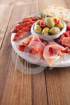 Platter of serrano jamon Cured Meat, Ciabatta, chorizo and olive