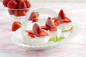 Platter of strawberry meringue nests with mint photo