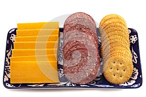 Platter of Summer Sausage Crackers and Cheddar Cheese on a White Background