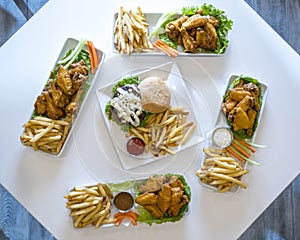 Platters of chicken wings, cheeseburgers, and french fries