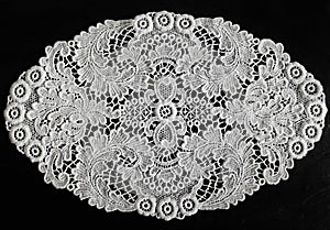 Plauener spitze (Plauen lace) white doily on black background