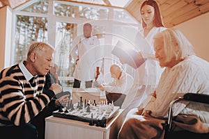 Play Chess. Sitting Woman. Young and Old People.