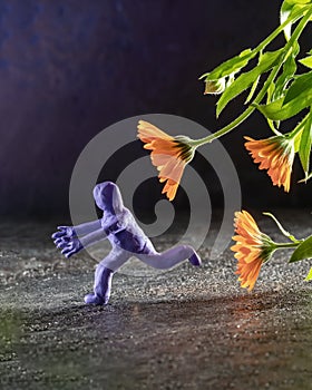 Play-doh character running away from calendula flower