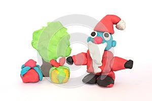 Play doh sculpture of Santa Claus on white background