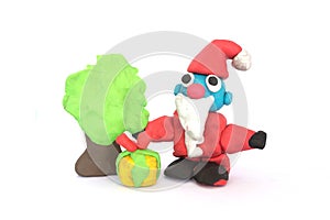 Play doh sculpture of Santa Claus on white background