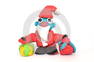 Play doh sculpture of Santa Claus on white background