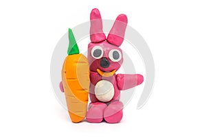 Play dough rabbit hold carrot on white background
