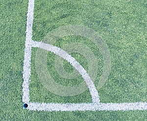 Play field corner, green grass texture of football or soccer field. Marked corner