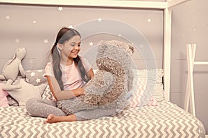 Play games. Favorite toy. Girl child hug teddy bear in her bedroom. Pleasant time in cozy bedroom. Girl kid long hair
