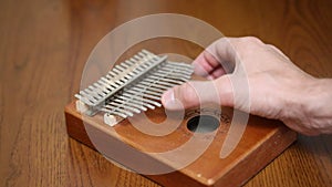 Play on kalimba on the table close-up