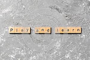 Play and learn word written on wood block. play and learn text on table, concept
