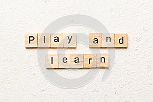 play and learn word written on wood block. play and learn text on table, concept