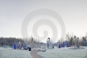 Play park outdoors with frozen grass during winter