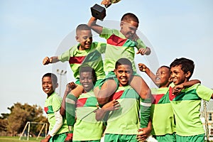 Play with passion and you will win. Shot of a boys soccer team celebrating their victory on a sports field.