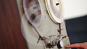 Play and rewind the tape in the old reel tape recorder, Old reel-to-reel tape deck, the tape is twisted in coils on